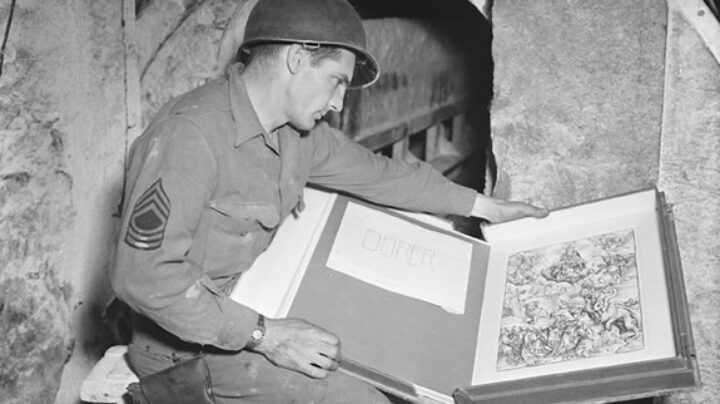 An American GI inspects a looted Durer print in the Merkers salt mine complexines.