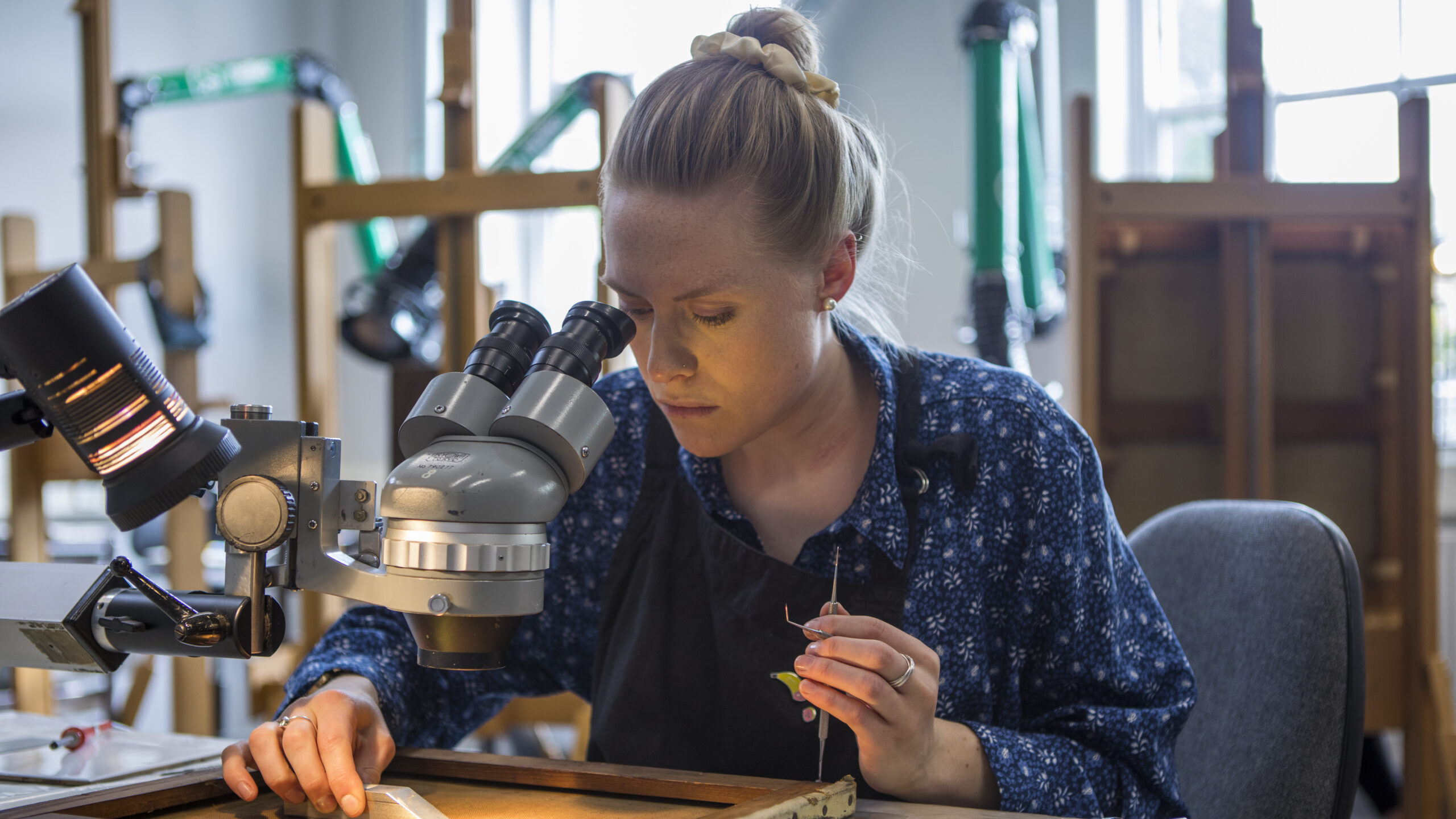 Woman looking into miscroscope