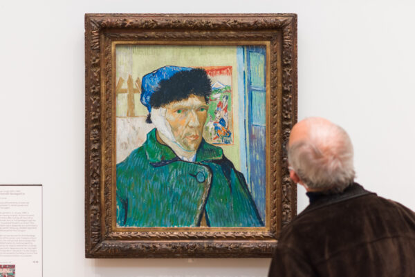 Man looking at painting