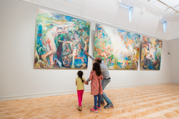 A family looks at a painting