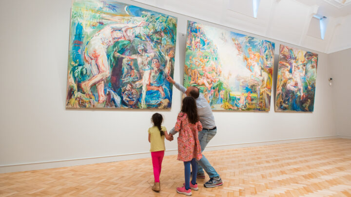 A family looks at a painting