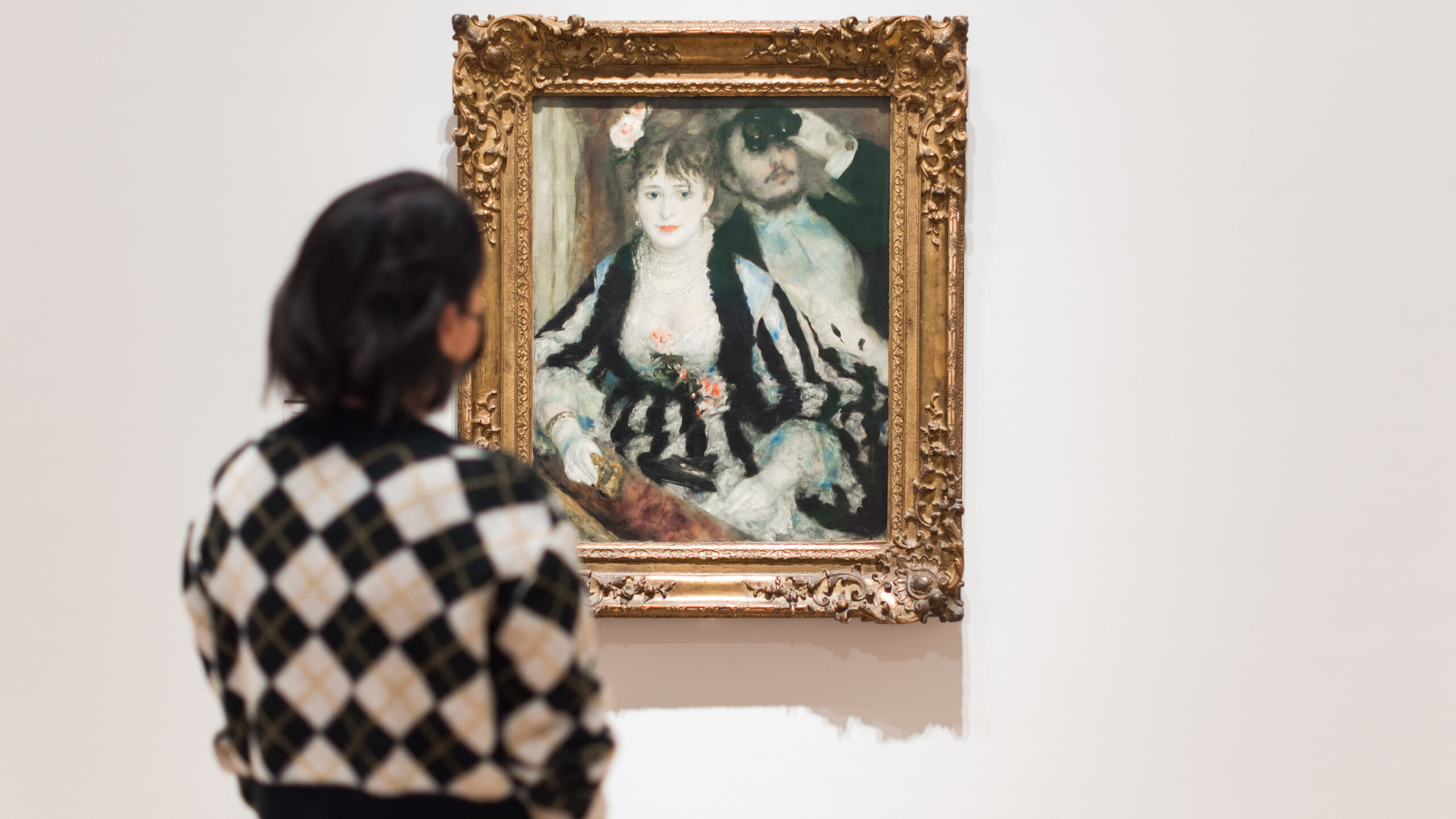 Lady looking at Pierre-Auguste Renoir's La Loge in the renovated Courtauld Gallery