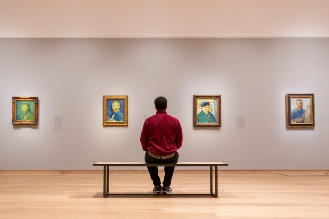 Photo of man looking at Van Gogh paintings