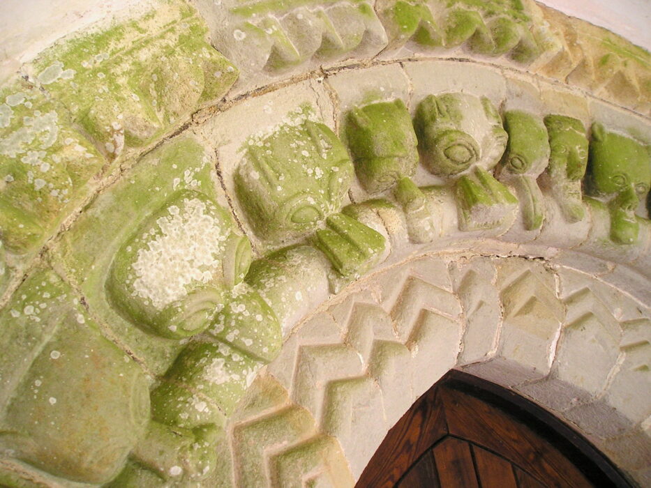 Photograph of a discoloured stone carved archway