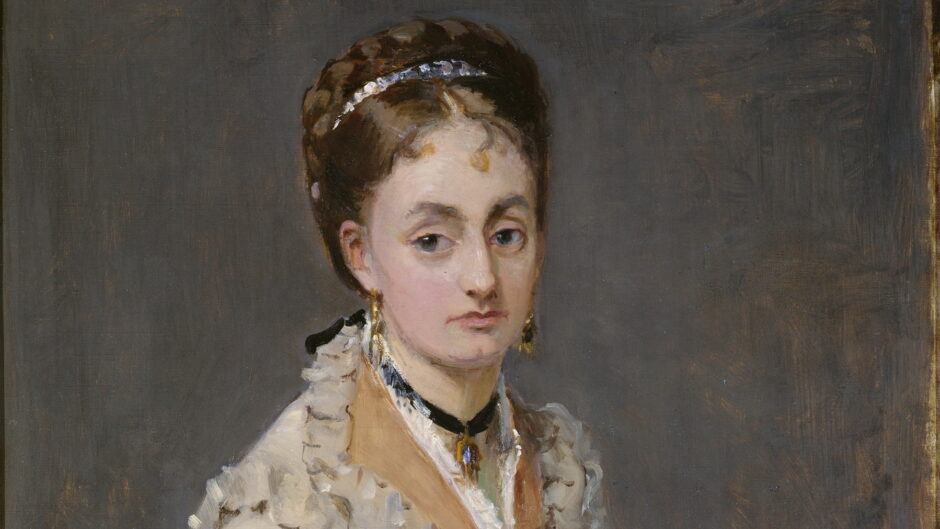 The woman wears a white dress and purple flowers tucked in her neckline. She looks out with a blank expression.