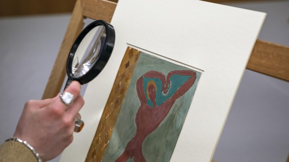 Hand holding magnifying glass