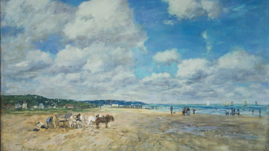 A beach with horses, tourists. There are small sailboats in the distance on the sea, and a small town.