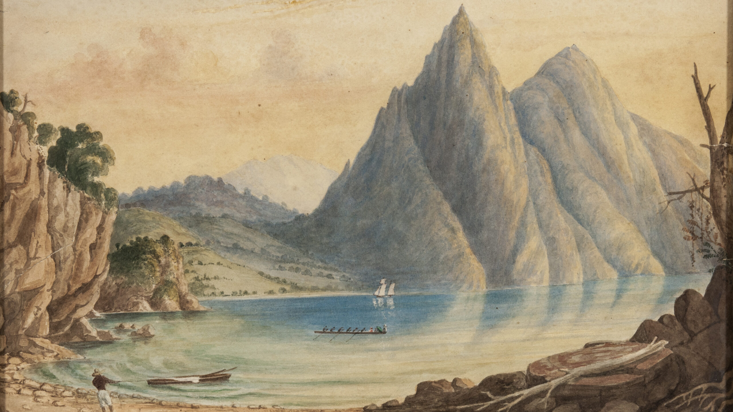 Watercolour painting depicting a lake surrounded by mountains. In the bottom left you can see a figure dragging a boat in to shore and there are more boats shown in the rest of the lake