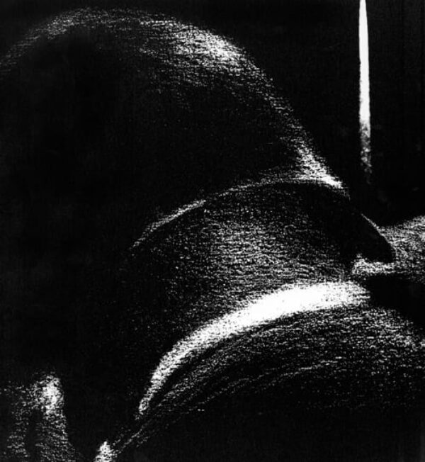 Close up black and white photograph of the back of a male figure's head