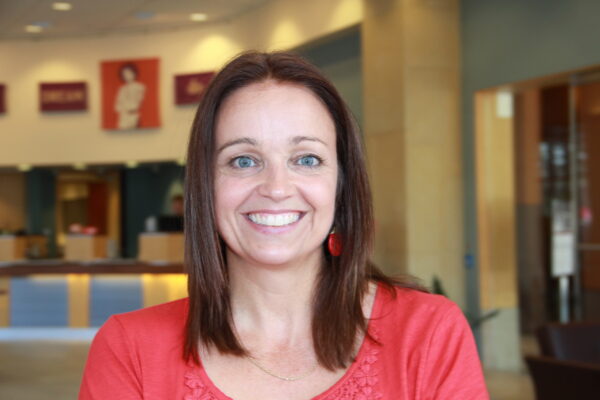 Photograph of a smiling woman facing the camera