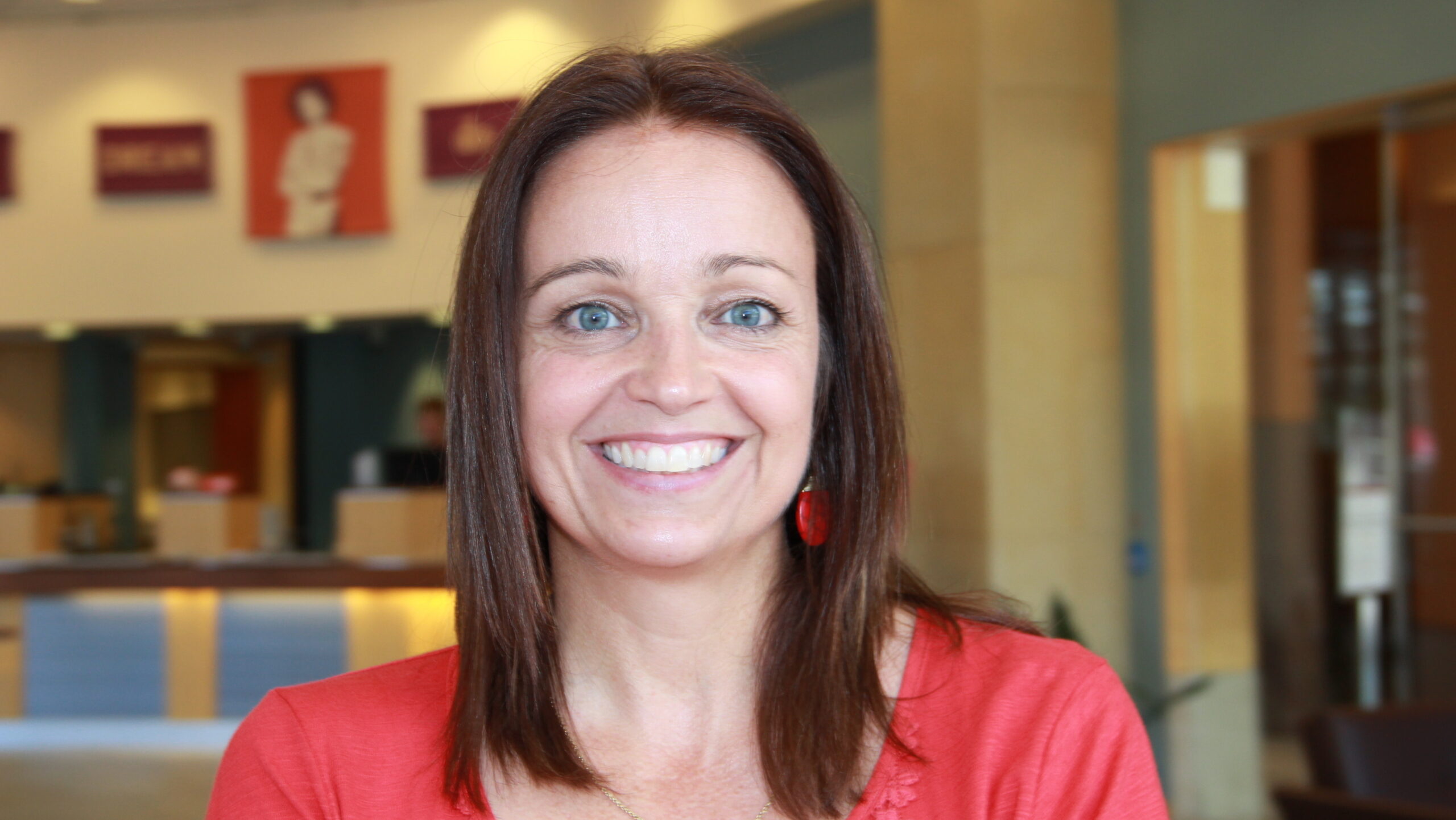 Photograph of a smiling woman facing the camera