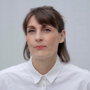 Head and shoulders photograph of a woman in a white shirt.