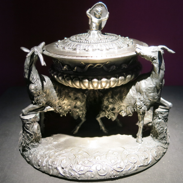 An ornamental silver bowl or dish flanked by the figures of two goats or deer