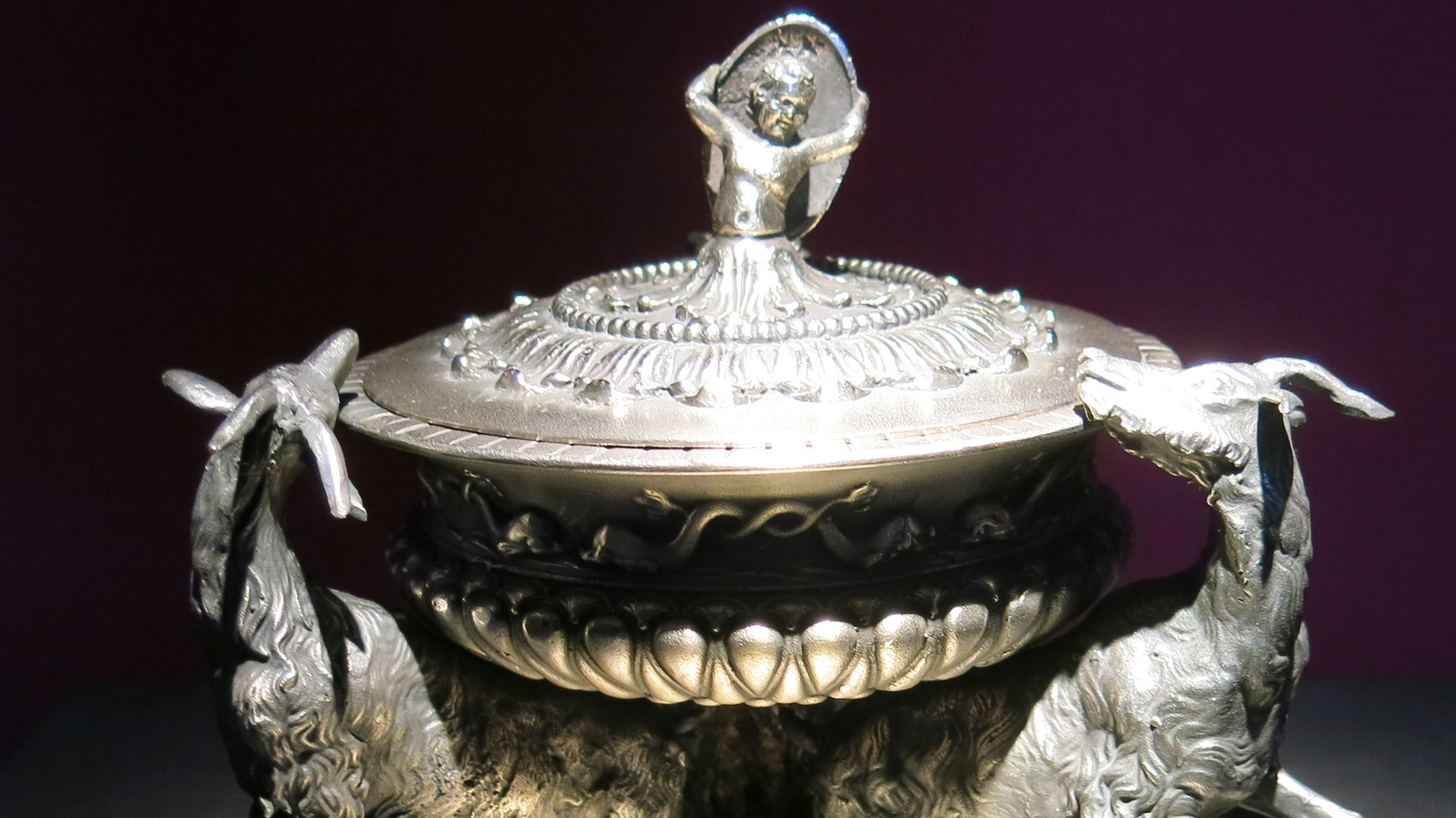 An ornamental silver bowl or dish flanked by the figures of two goats or deer