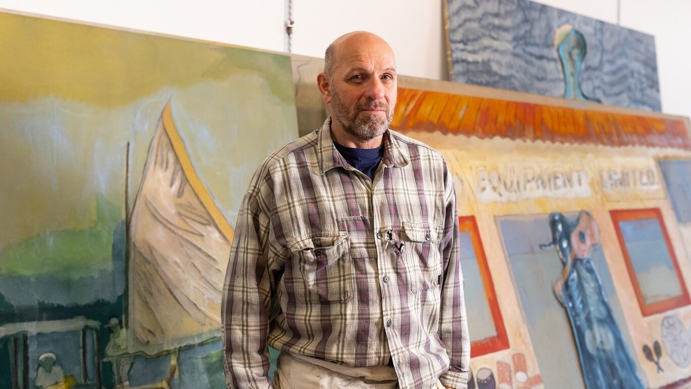 A portrait of the artist Peter Doig in his studio