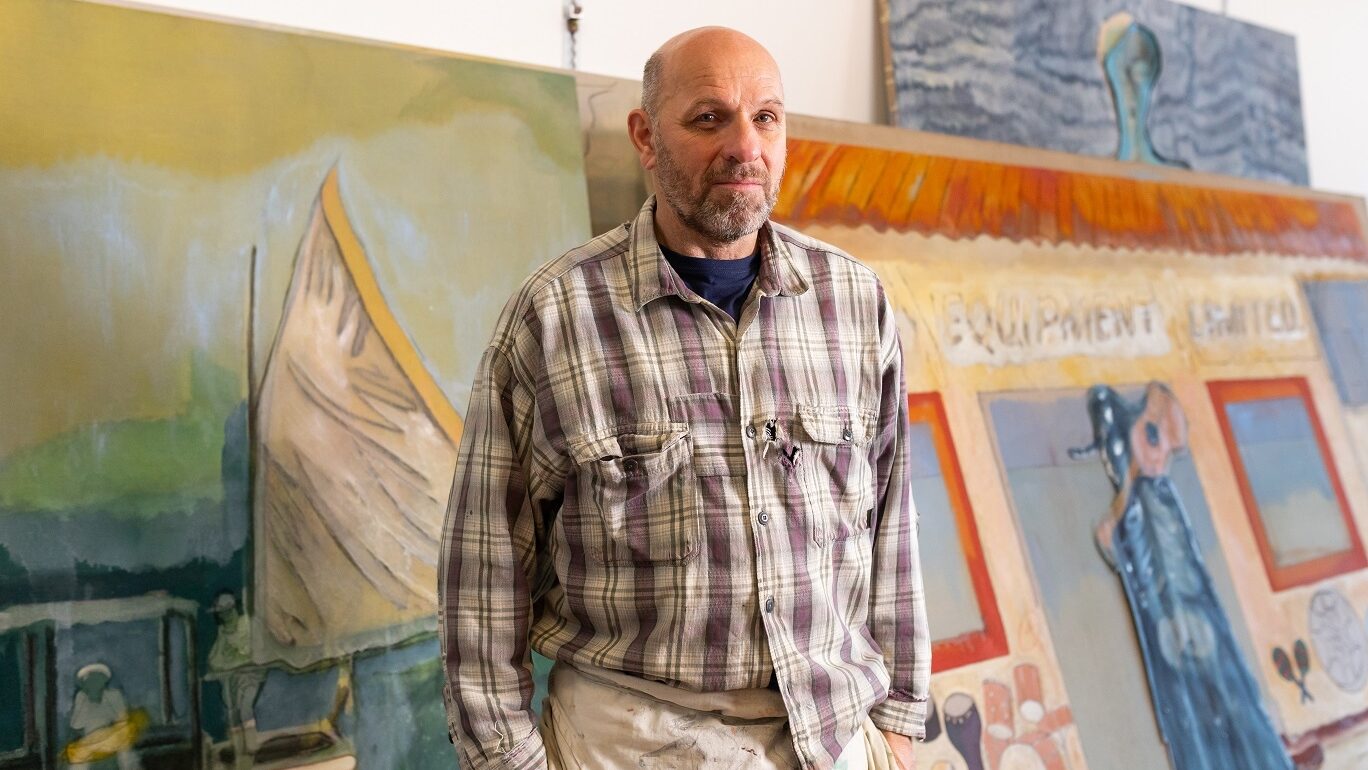 A portrait of the artist Peter Doig in his studio