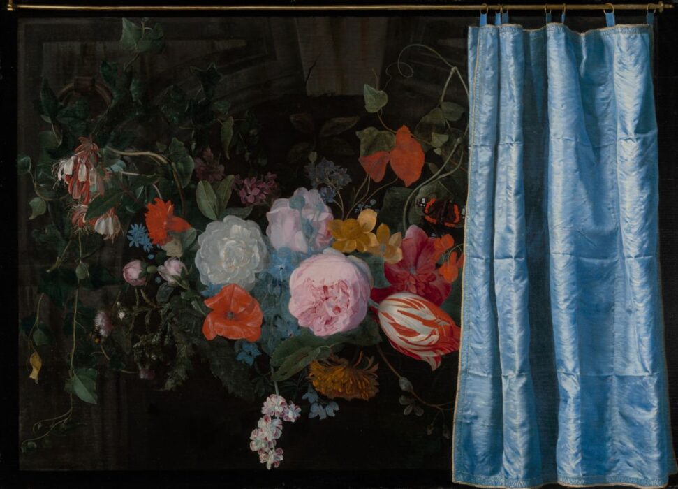 A bouquet of flowers half hidden behind a curtain.