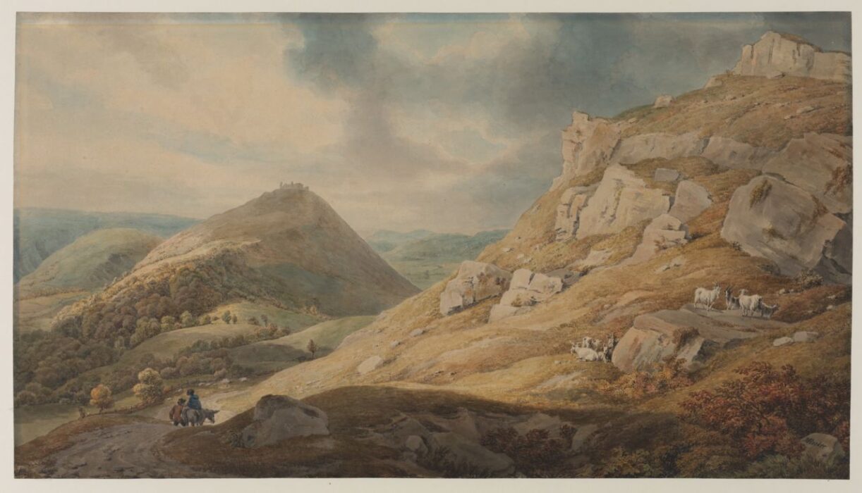 A stony, hilly landscape with two small figures and a donkey.
