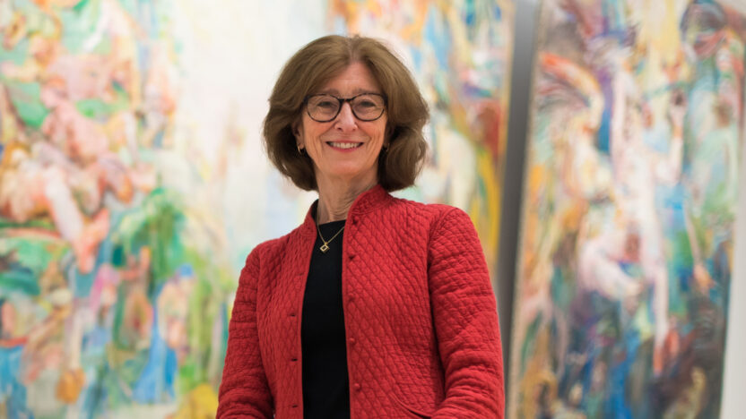 Deborah Swallow in front of colourful paintings