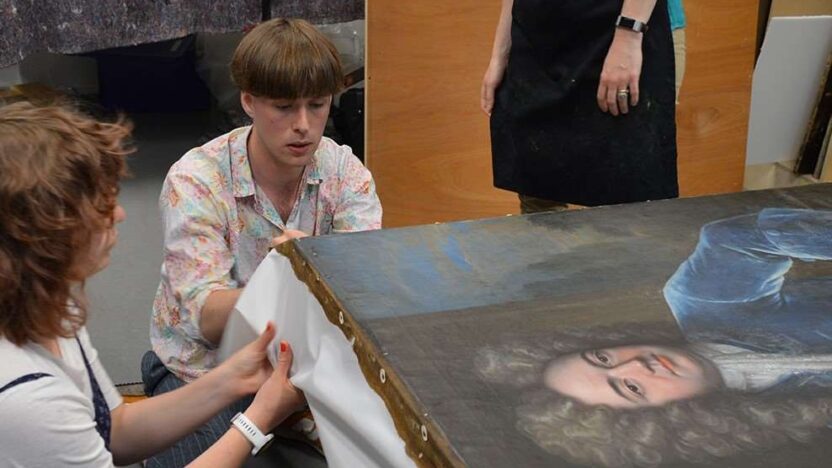 Jack Chauncy and India Ferguson stretching the white polyester sailcloth strips around the stretcher