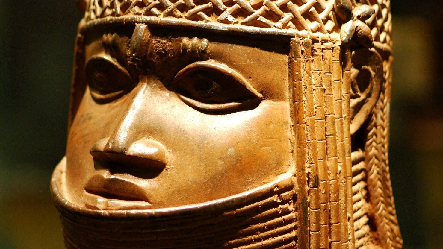 A mask of an oba made in bronze; the neck is formed of coils and they wear a woven crown