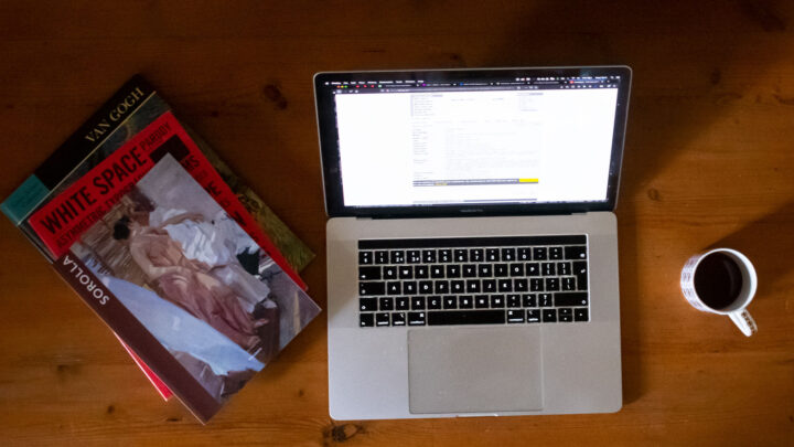 Art books on table with laptop