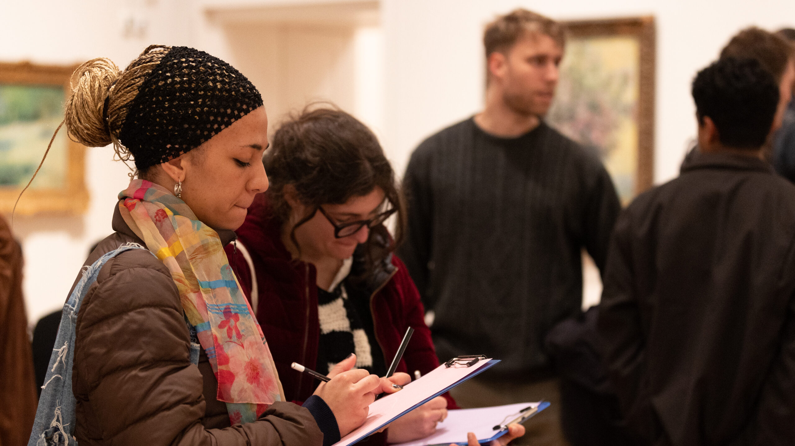 A woman drawing in the Gallery at the Morgan Stanley Lates