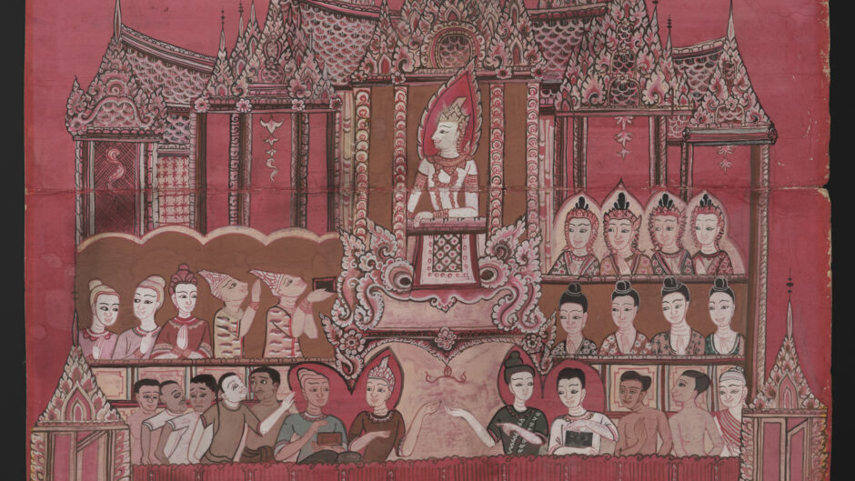 Photograph of a page from a Buddhist manuscript. The page is a red colour and there is an image depicting a lecture on cosmology being delivered by a central figure to a crowd of people.