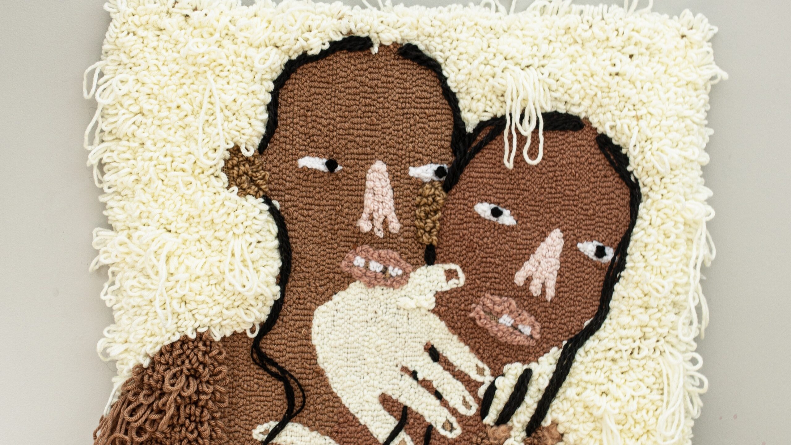 a mixed media work showing two black figures holding each other