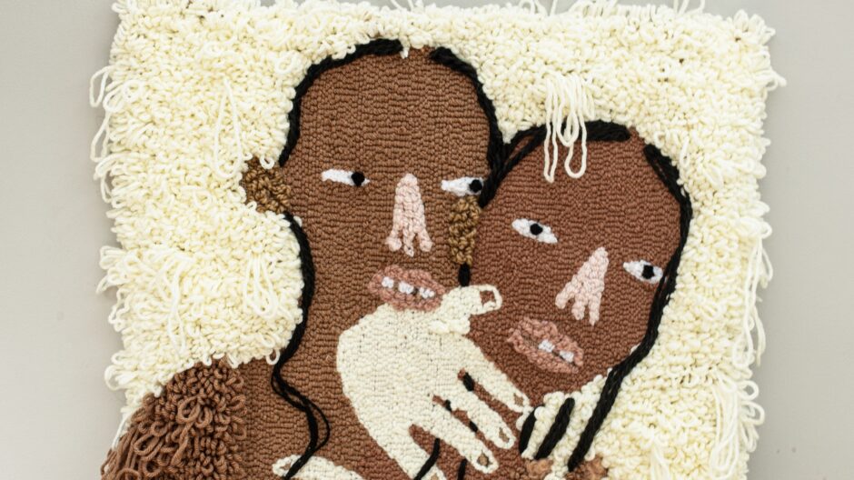 a mixed media work showing two black figures holding each other