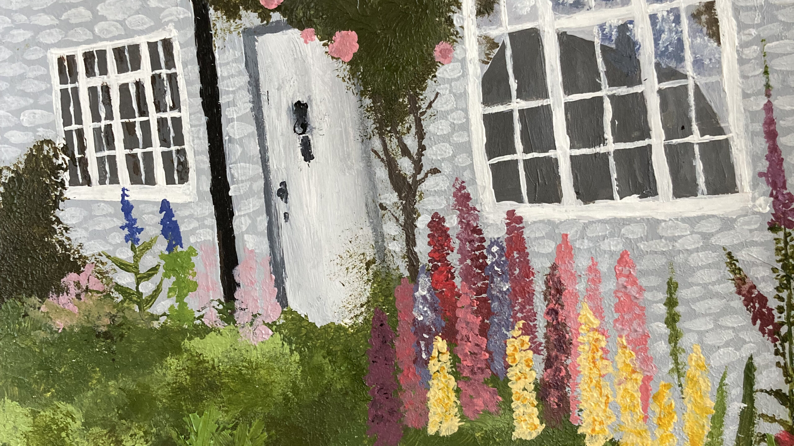 A painting in an impressionist style. In the foreground there are green plants, and colourful flowers. In the centre of the painting, there is a tree with pink flowers. The background shows a grey house with large windows.