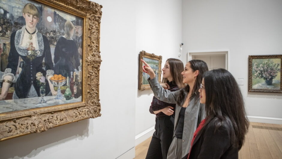 three female students looking at a painting in the Courtauld's gallery
