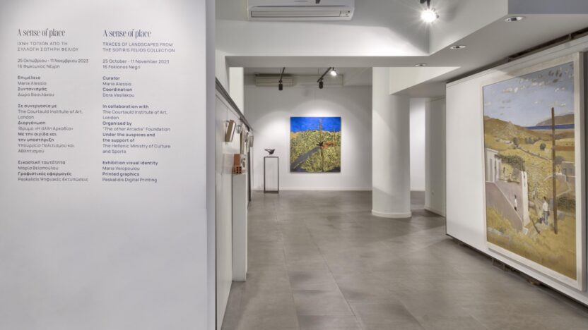 An installation view of 'A Sense of Space' exhibition from the SFC residency programme 2023, showing artworks on the walls of a white room with a grey marble floor, and wall text describing the exhibition on one pillar written in both Greek and English.