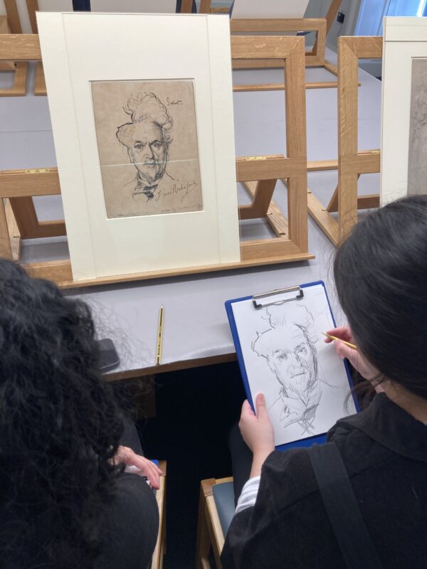 two female students copying on paper one of the drawings from the Courtauld's drawing collection