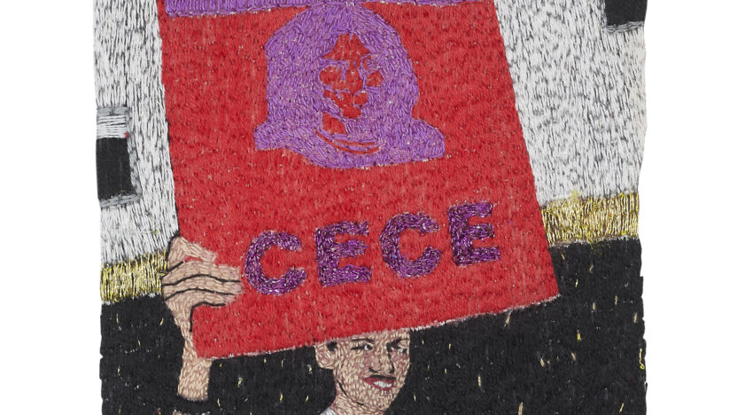 A textile work by Jacqueline Mautner showing a person holding a red sign reading 