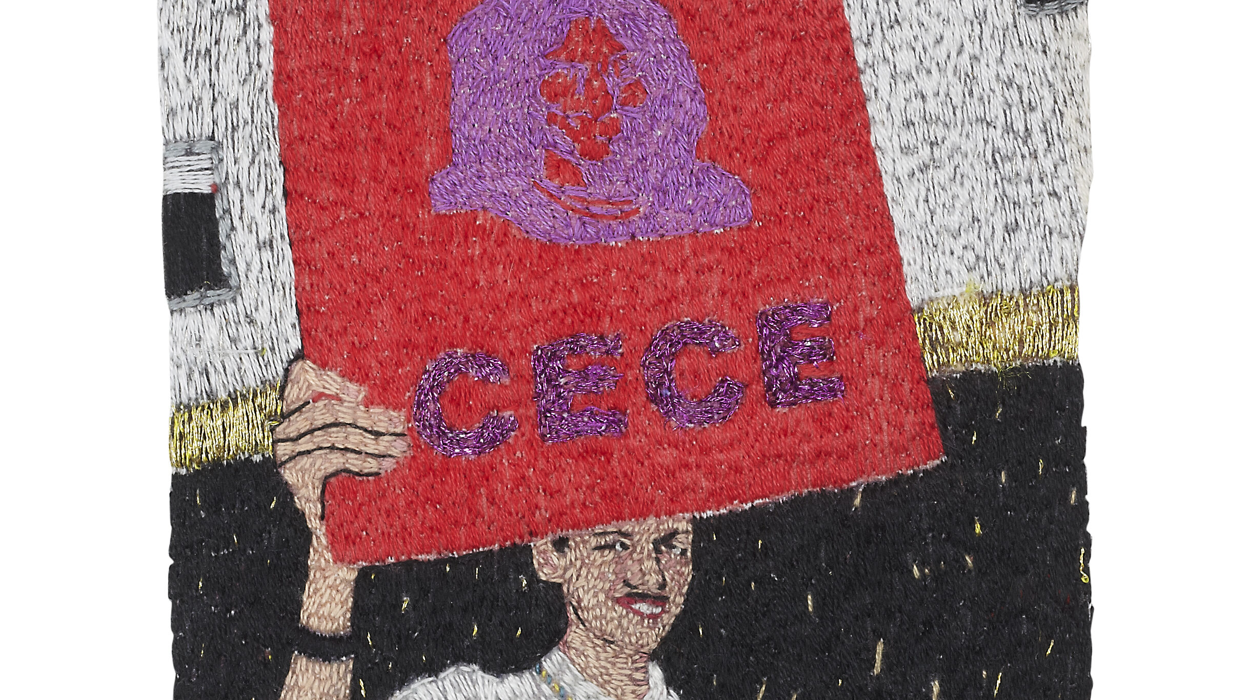 A textile work by Jacqueline Mautner showing a person holding a red sign reading 