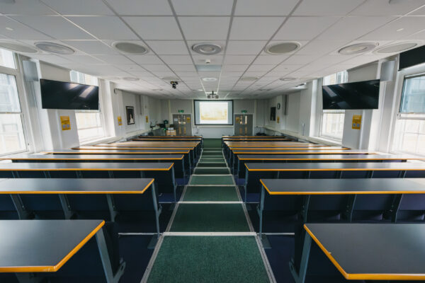 Lecture Theatre. Audience view including screen and speaker stand.
