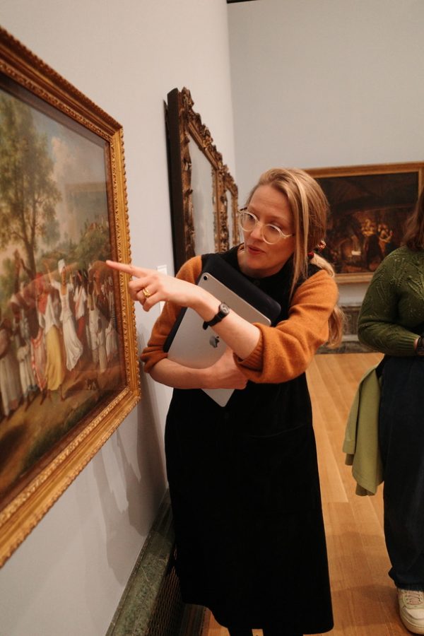 Dr Esther Chadwick teaching at Tate Britain, pointing out a detail in a historic artwork.