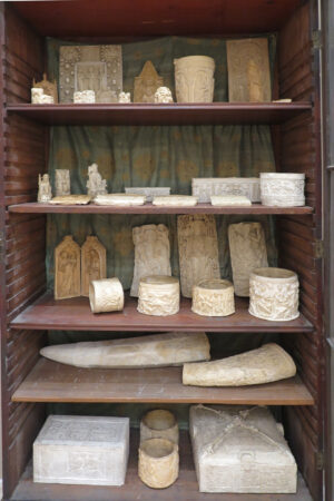 view of a cabinet set of shelves with artifacts on them