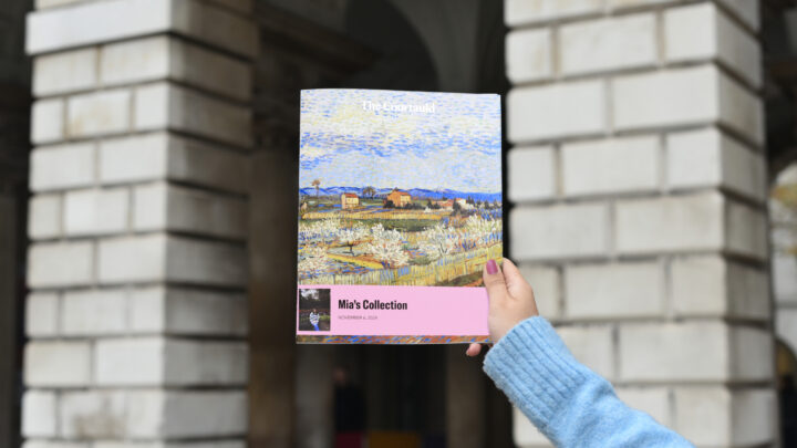 A hand holding up a personalised MYSE catalogue outside The Courtauld.