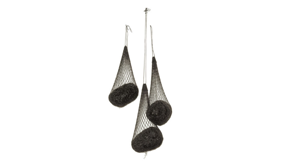 Sculpture with three dark nets hanging