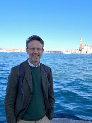 Picture of Guido Rebecchini standing in front of the Venice canal