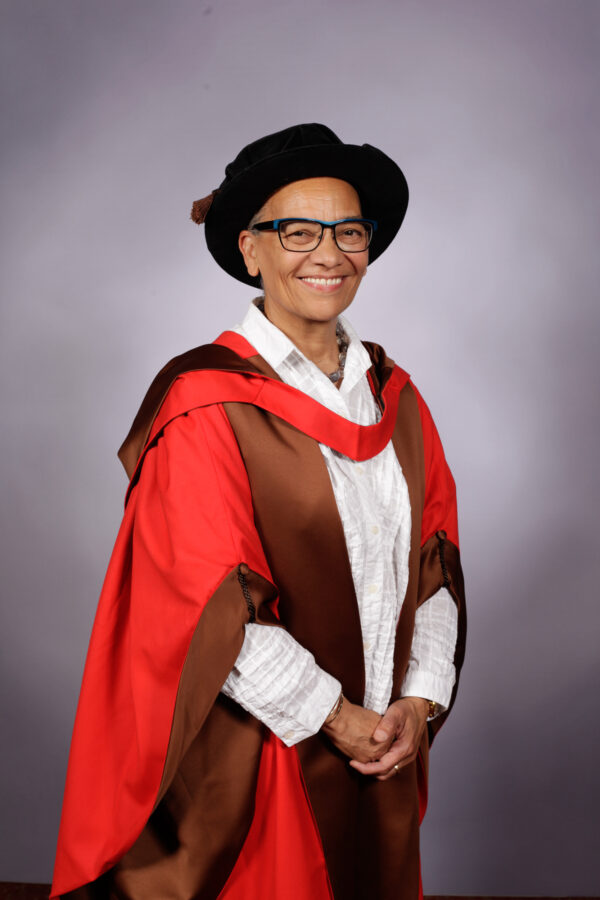 Professor Lubaina Himid at The Courtauld Graduation, wearing a brown gown with a red trim and graduation cap