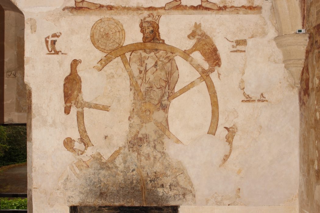 Photograph of richly coloured medieval wall paintings from Longthorpe Tower, showing figures and decorative motifs from 14th-century mural scene
