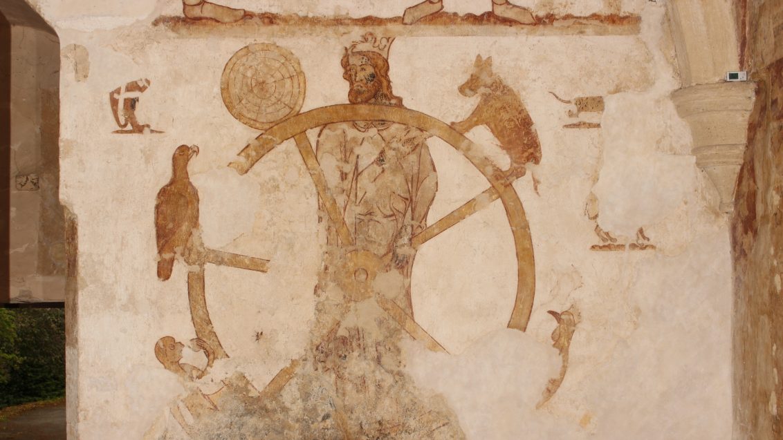 Photograph of richly coloured medieval wall paintings from Longthorpe Tower, showing figures and decorative motifs from 14th-century mural scene