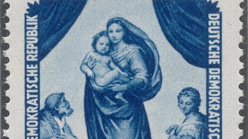 A vintage blue postage stamp from the German Democratic Republic depicting Raphael’s Sistine Madonna. The design shows the Madonna holding the Christ Child, flanked by saints, with draped curtains framing the scene. The stamp is marked 