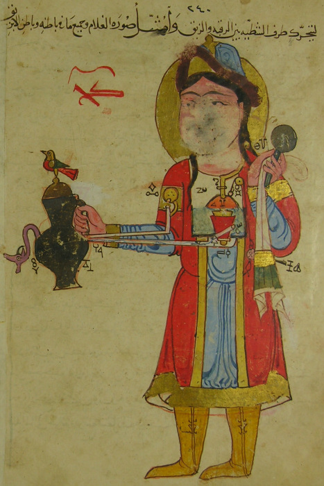 Medieval Ottoman Illustration of a liquid-dispenser shaped as an enslaved servant, from Ibn al-Razzaz al-Jazari’s Compendium of the Mechanical Arts (1206, Amid, Turkey). The automaton figure wears a red robe and gold boots, holding a vessel with a bird on top, with pipes and mechanisms connecting to a cup. Folio 121v, Topkapı Palace Library, Istanbul (Ms. Ahmet III 3472).