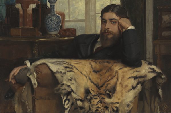 A 19th-century painting of a bearded man in a dark suit, reclining thoughtfully on a chair draped with a tiger skin, with books and a vase in the background.