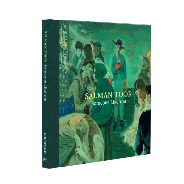Side-on view of an exhibition catalogue featuring a painting of a man in a bar. The book is bound in dark green.
