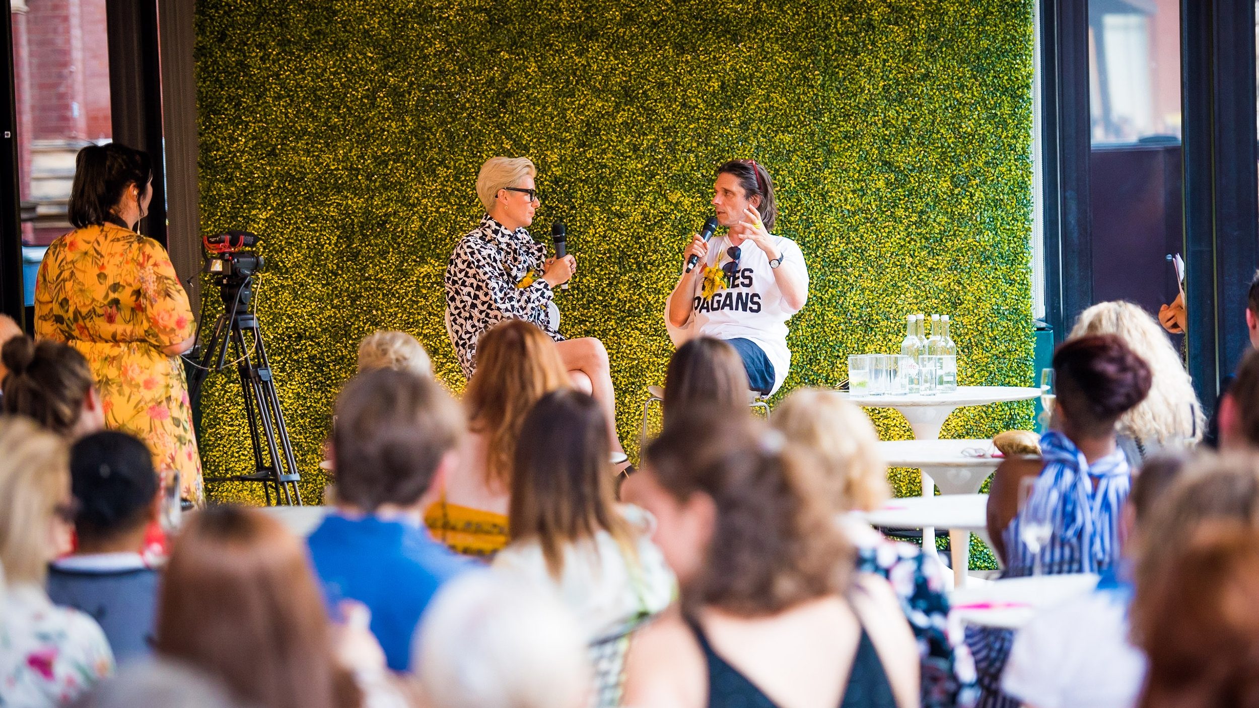 Two people in conversation on stage.